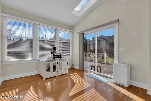 an aerial view of a city with lots of residential buildings ocean and mountain view in back