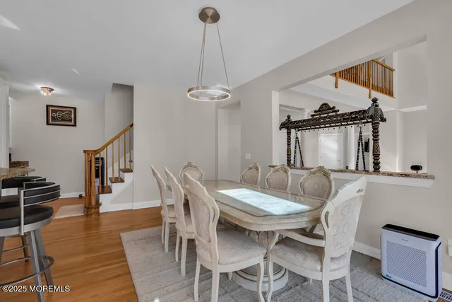 an aerial view of a city with lots of residential buildings and ocean view in back