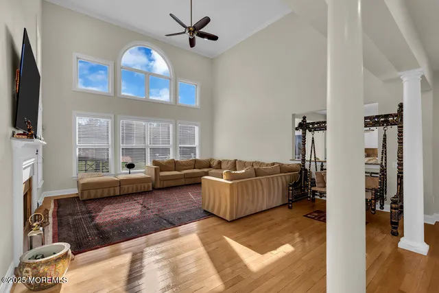 an aerial view of residential houses with outdoor space and trees
