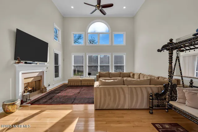 an aerial view of residential houses with outdoor space and trees
