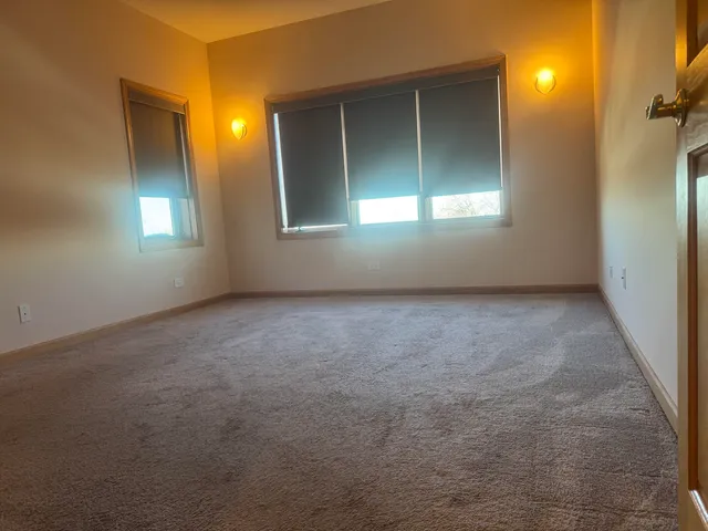 an empty room with windows and closet