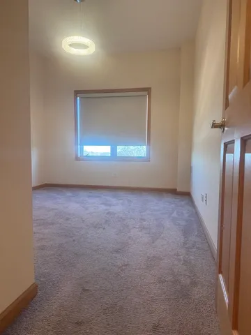 an empty room with a empty space and windows