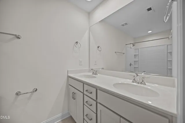 a bedroom with bed a chandelier and a window