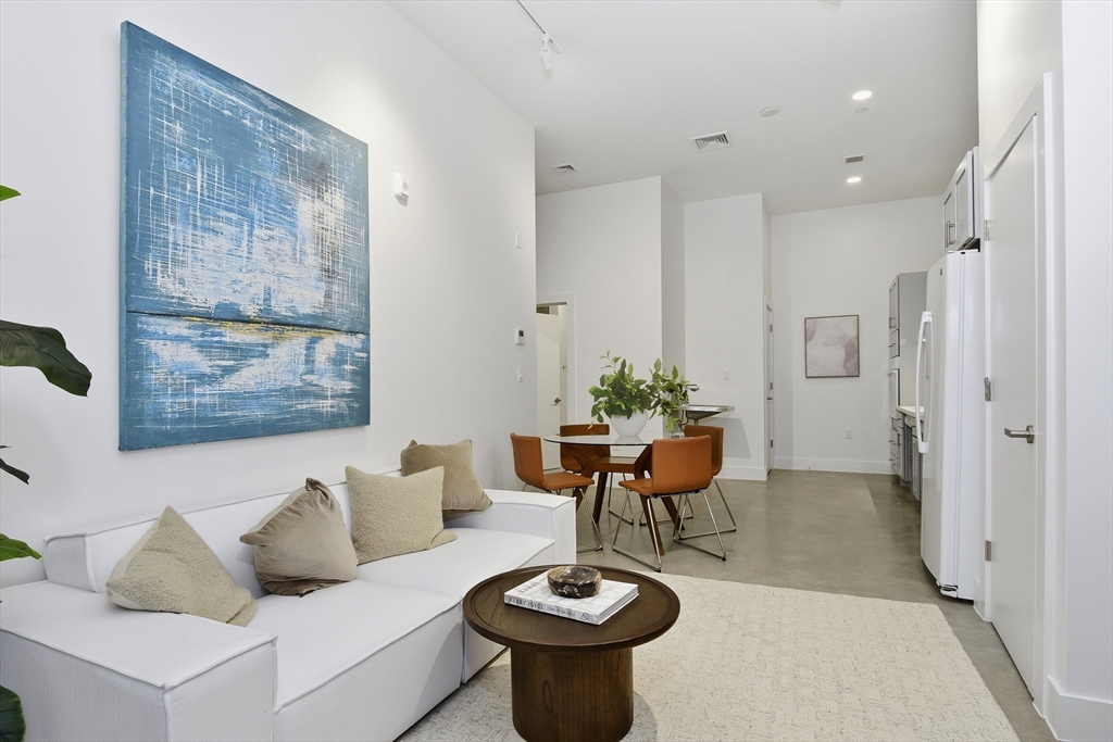 10 Stonley Road, Unit 102 Boston, MA 02130 - Photo 5 of 13 a living room with furniture and a table
