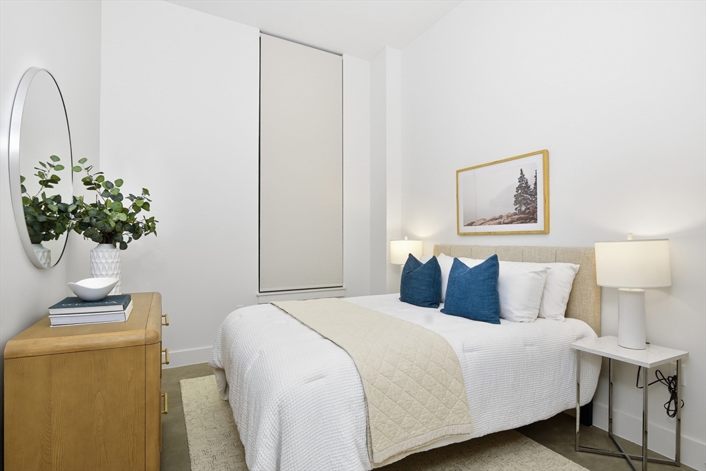 10 Stonley Road, Unit 102 Boston, MA 02130 - Photo 7 of 13 a bedroom with a bed and a potted plant