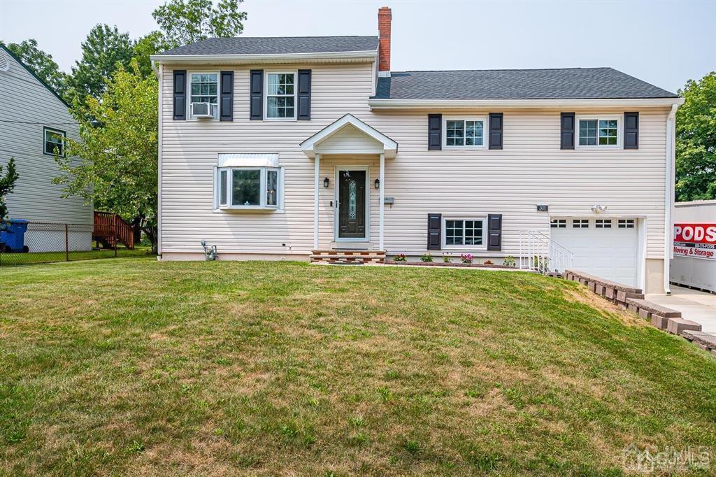 301 Colonia Boulevard Colonia, NJ 07067 - Photo 1 of 51 a front view of a house with a yard