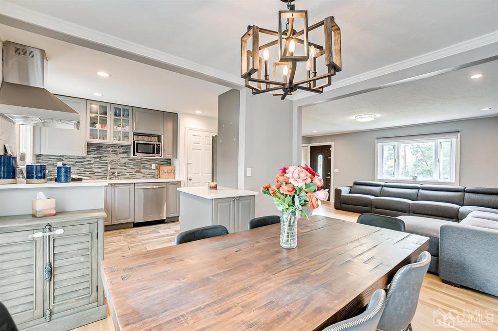 301 Colonia Boulevard Colonia, NJ 07067 - Photo 21 of 51 a kitchen with stainless steel appliances kitchen island granite countertop a table chairs and a refrigerator
