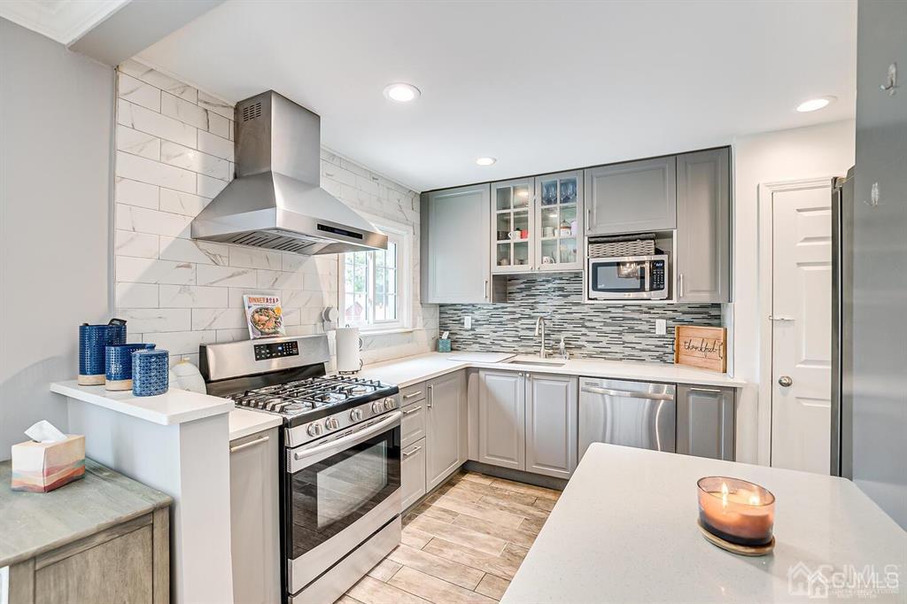 301 Colonia Boulevard Colonia, NJ 07067 - Photo 22 of 51 a kitchen with stainless steel appliances granite countertop a stove and a sink