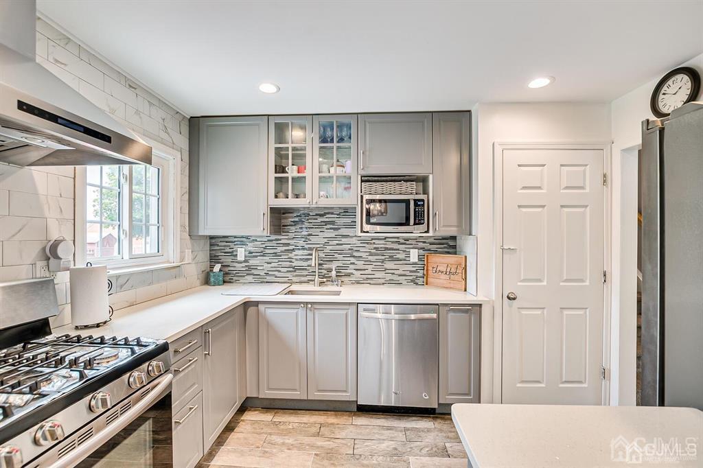 301 Colonia Boulevard Colonia, NJ 07067 - Photo 24 of 51 a kitchen with stainless steel appliances granite countertop a stove a sink and a refrigerator