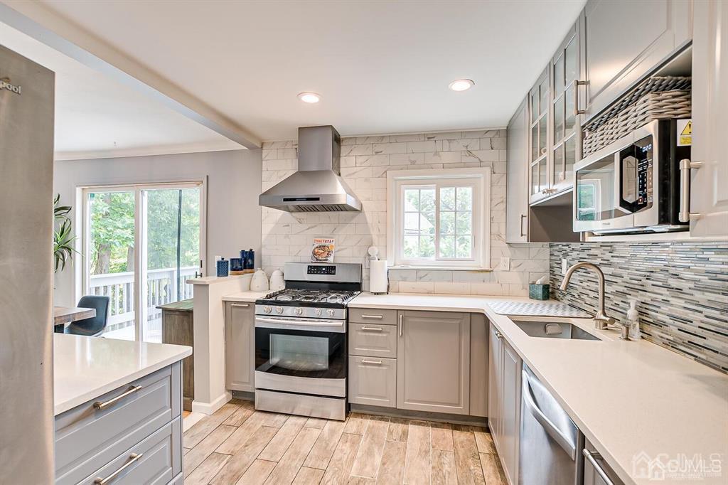 301 Colonia Boulevard Colonia, NJ 07067 - Photo 25 of 51 a kitchen with stainless steel appliances a stove sink and cabinets