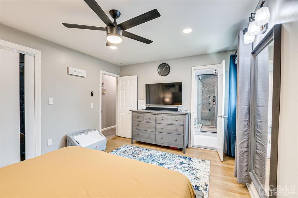 301 Colonia Boulevard Colonia, NJ 07067 - Photo 28 of 51 a bedroom with a bed and a flat screen tv