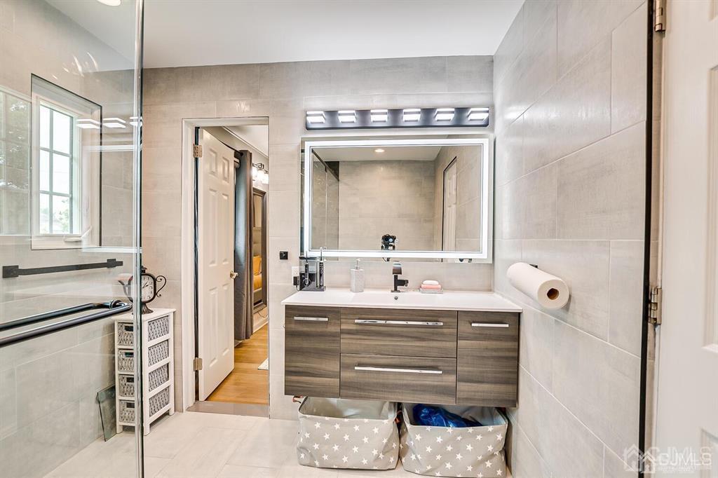 301 Colonia Boulevard Colonia, NJ 07067 - Photo 30 of 51 a bathroom with a sink and a mirror