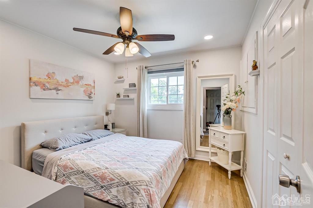 301 Colonia Boulevard Colonia, NJ 07067 - Photo 31 of 51 a bedroom with a bed and a chandelier