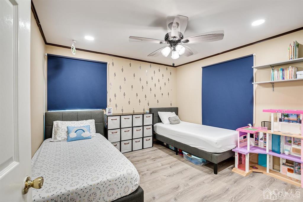 301 Colonia Boulevard Colonia, NJ 07067 - Photo 34 of 51 a bedroom with a bed and a chandelier