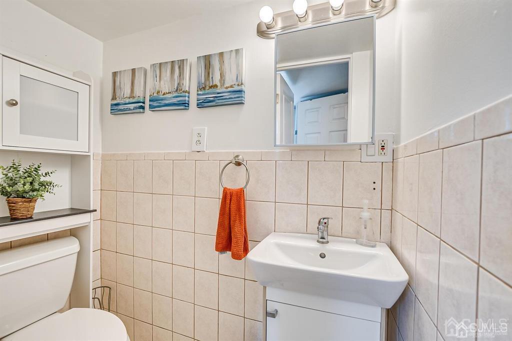 301 Colonia Boulevard Colonia, NJ 07067 - Photo 38 of 51 a bathroom with a sink a toilet and mirror