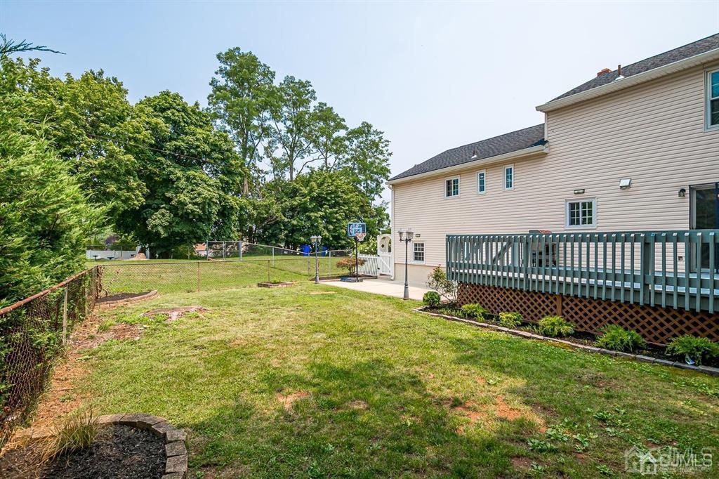 301 Colonia Boulevard Colonia, NJ 07067 - Photo 43 of 51 a view of a house with a yard and a fence