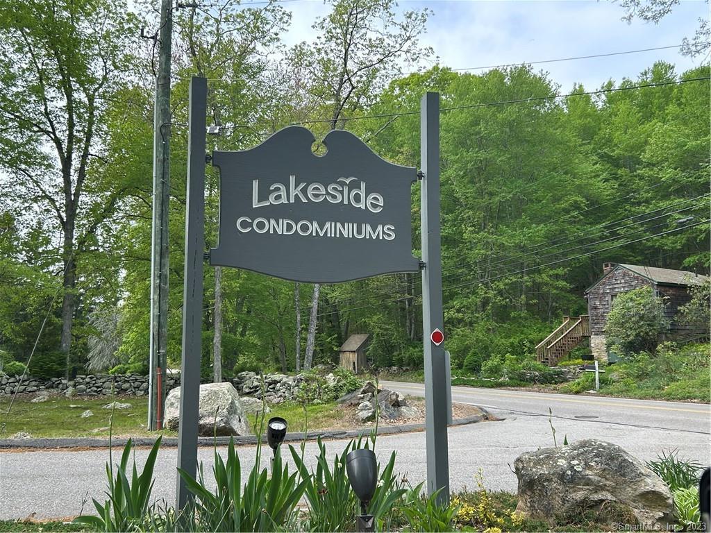 12 Lakeside Drive, Unit M Ledyard, CT 06339 - Photo 1 of 1 a view of a street sign under a large tree