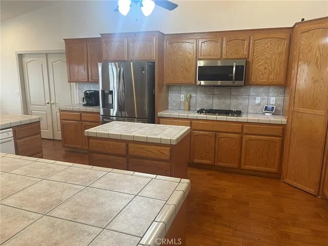 a view of a hallway with wooden floor and stairs