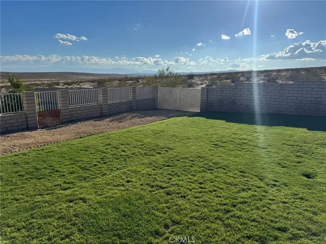 a front view of a house with a garden and yard