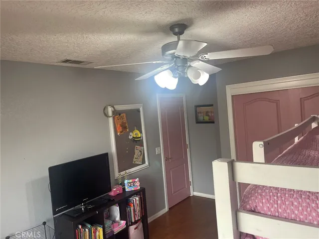 a spacious bedroom with a bed and a chandelier