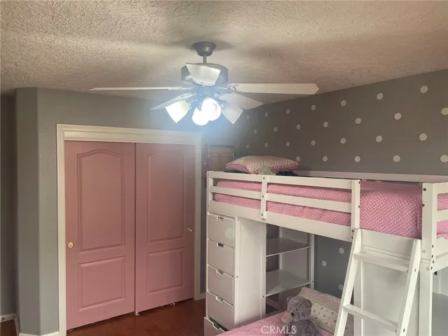 a spacious bedroom with a bed and a chandelier