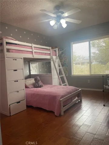 a bedroom with a bed window and a chandelier