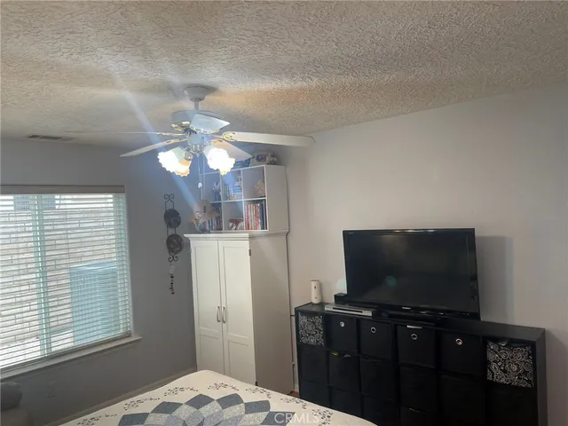 a bathroom with a granite countertop toilet and a shower