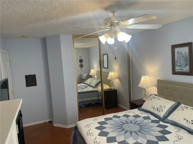 a bathroom with a granite countertop sink toilet a mirror and shower