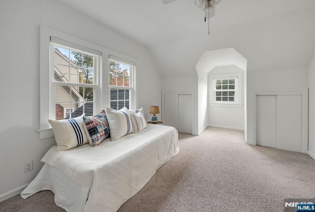 431 Goffle Road Wyckoff, NJ 07481 - Photo 12 of 19 a bedroom with a large bed and a chandelier