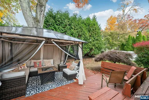 a view of deck with chairs and wooden fence