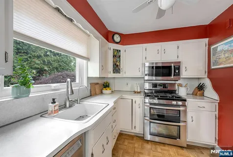 a kitchen that has a sink and a stove top oven