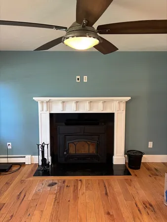 a view of a livingroom with fireplace and wooden floor