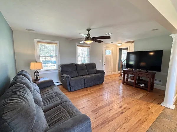a living room with furniture and a flat screen tv