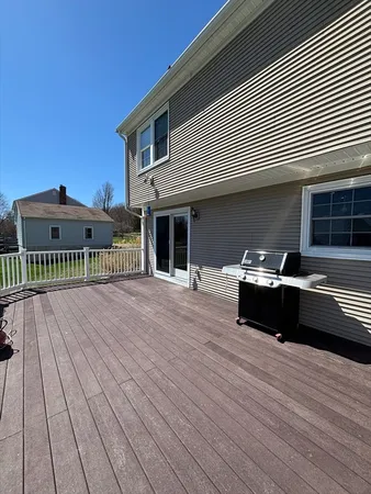 a view of a roof deck with wooden floor and fence