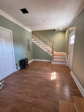 a view of entryway and hall with wooden floor