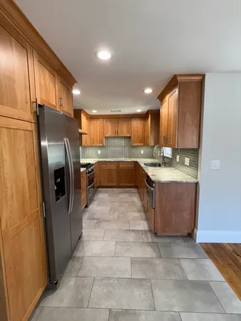 a kitchen with stainless steel appliances granite countertop a refrigerator and a sink