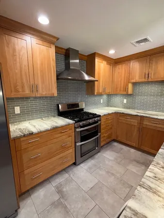 a kitchen with a sink stove and cabinets