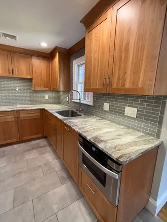 a kitchen with a sink stove and cabinets