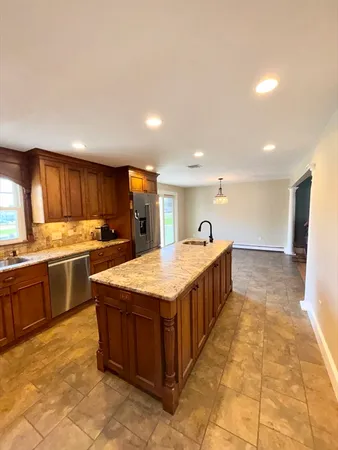 a kitchen with stainless steel appliances granite countertop a stove and a sink