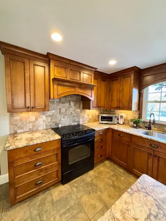 a kitchen with stainless steel appliances granite countertop a stove and a sink
