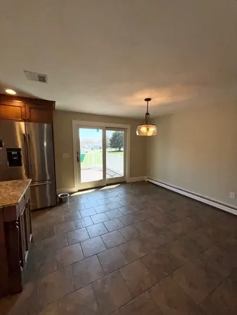 an empty room with windows and closet