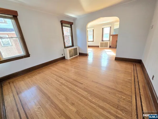 a view of a room with wooden floor and a window