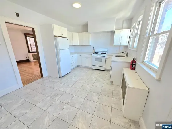 a kitchen with a sink a stove cabinets and counter space