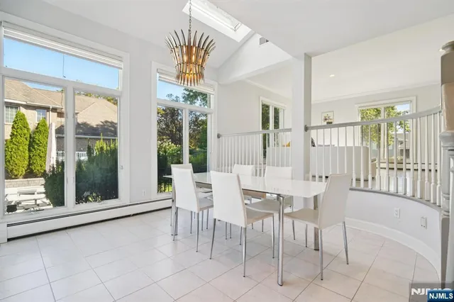 a dining room with furniture and large windows