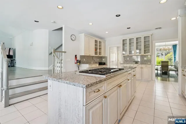 a kitchen with a stove and white cabinets