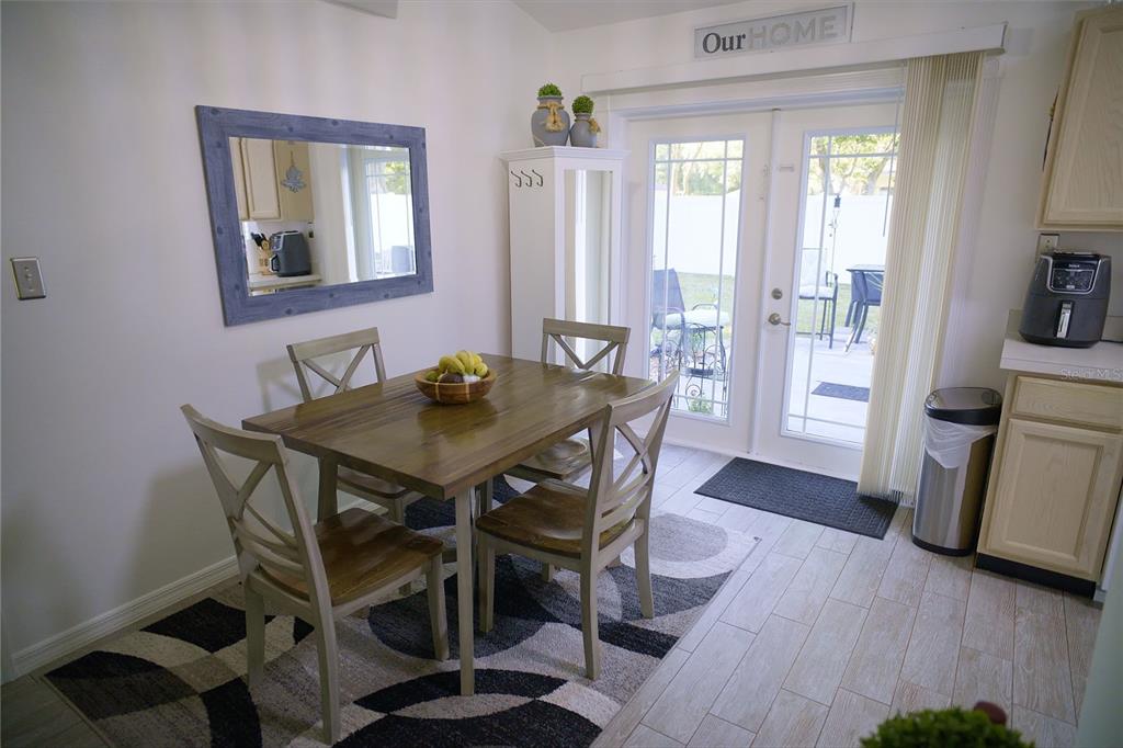 408 Raymond Street Minneola, FL 34715 - Photo 11 of 21 a view of a dining room with furniture and wooden floor