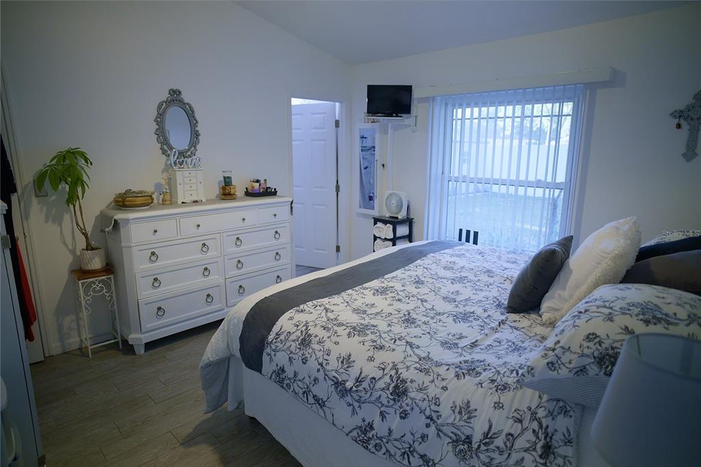 408 Raymond Street Minneola, FL 34715 - Photo 13 of 21 a bedroom with a bed and a window