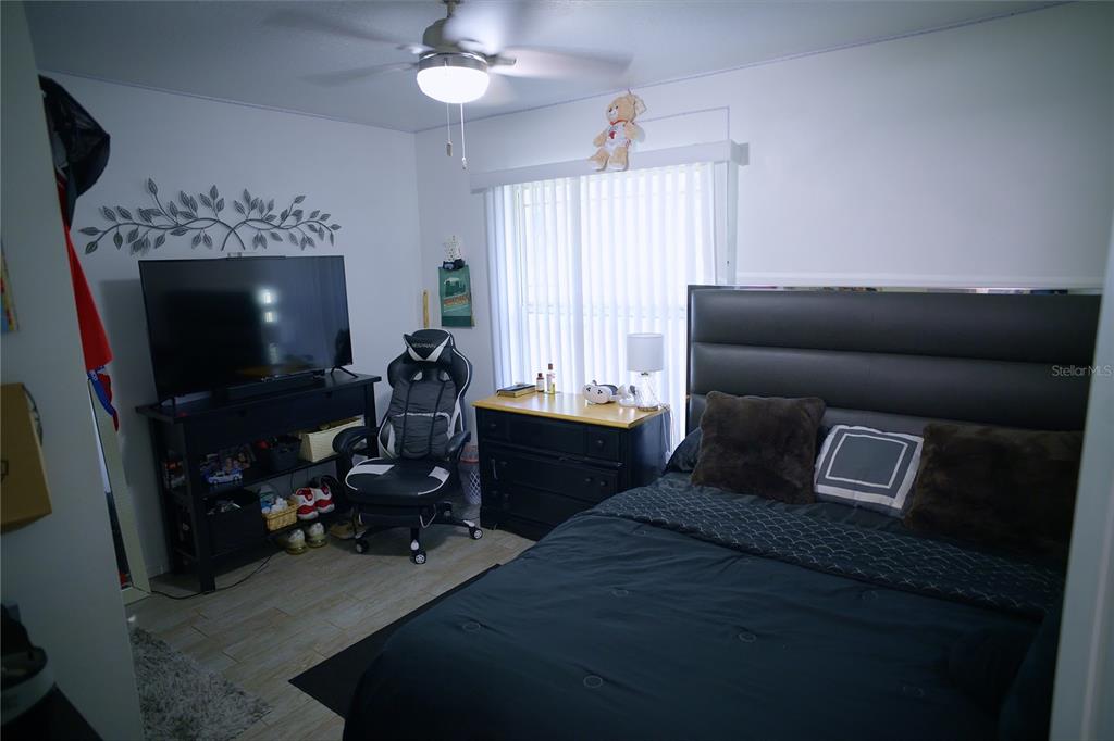 408 Raymond Street Minneola, FL 34715 - Photo 15 of 21 a living room with furniture a fireplace and a flat screen tv