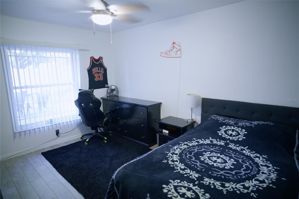 408 Raymond Street Minneola, FL 34715 - Photo 16 of 21 a bedroom with a bed and a window