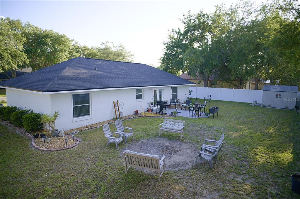 408 Raymond Street Minneola, FL 34715 - Photo 19 of 21 a view of a house with backyard porch and sitting area